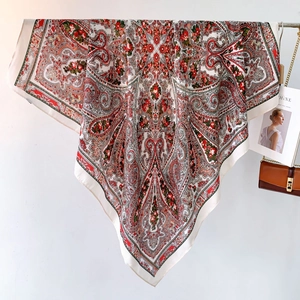 Detail of large paisley print silk scarf with intricate vintage floral patterns in deep red