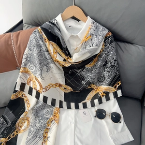 Chic chain print cotton linen scarf with baroque patterns draped over a white shirt