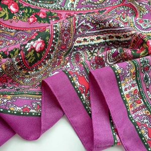 Detail of bohemian paisley and rose floral print on soft purple scarf with herringbone edge