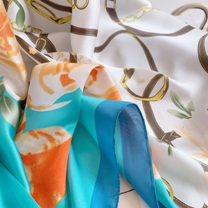 Detailed macro shot of silky satin fabric with floral prints and chain patterns