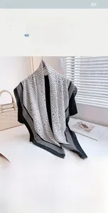 Close-up of geometric pattern silk scarf with herringbone texture in a lifestyle setting