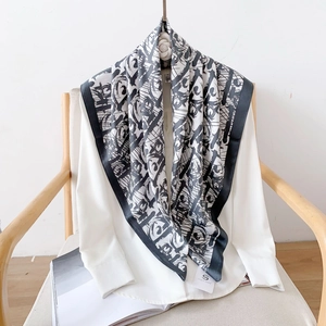 Detail of premium black and white silk scarf with abstract graffiti print on white shirt