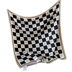 Checkerboard pattern silk scarf with golden monogram print and smooth satin finish