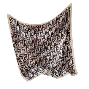 Elegant ivory and coffee silk-like square scarf featuring abstract monogram print in suspension