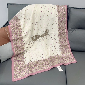 Detail of floral hem and horse carriage print on a breathable cotton linen scarf