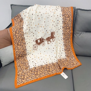 Detail of vintage carriage pattern on white linen scarf with bright orange hem finish