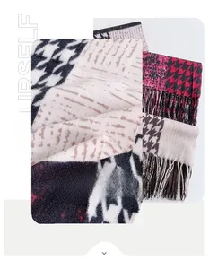 Detail of soft houndstooth cashmere scarf with decorative tassels and multi-color patterns