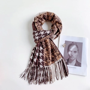 Detail of autumn houndstooth and leopard print scarf with soft fringe and earthy tones