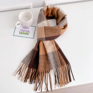 Close-up of brown plaid scarf with fringe tassels and soft cashmere-like texture