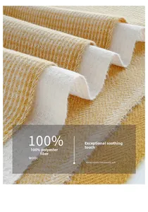 Macro detail of soft herringbone patterned fabric scarf with delicate fringe edges
