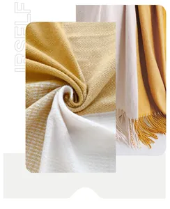Macro detail of yellow and cream faux cashmere scarf with herringbone weave and tassels
