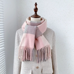 Detailed view of soft cashmere feel scarf with pink and grey plaid and tassel fringe