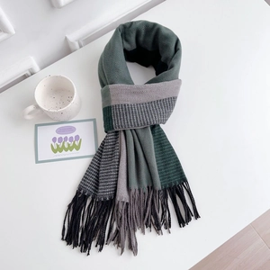 Detailed macro view of two-tone cashmere-feel scarf with herringbone pattern and tassels