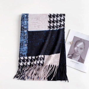 Close-up of houndstooth scarf with tassels, mixed with navy and beige patterns