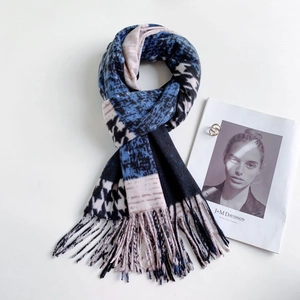Detail of houndstooth and leopard print scarf with soft fringe edges and patchwork design