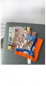 Detail of three baroque style square scarves with frayed edges in blue and orange patterns