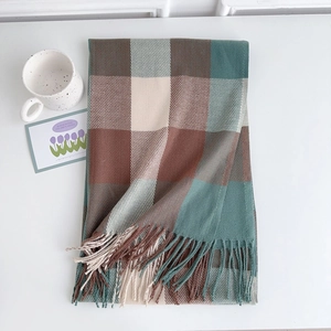 Close-up of thick plaid scarf texture with vintage green checker pattern and fringe detail