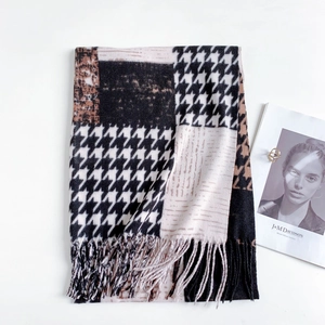 Detail of classic houndstooth scarf with black and brown blocks and long fringes
