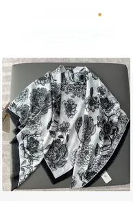 Detail of floral print scarf showing fringe edges and soft fabric texture on base