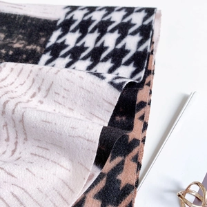 Detail of houndstooth and leopard print scarf fabric texture with soft cashmere feel