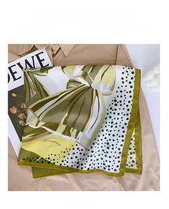 Detailed view of square silk scarf with grass green and white polka dot patterns