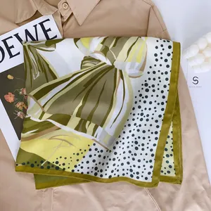 Elegant silk scarf with green and yellow color blocks and vintage polka dots on shirt