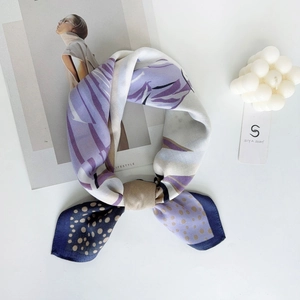 Detail of color-block silk scarf with dots and stripes pattern in elegant knot