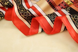 Detail of silk texture scarf with red stripes and European architecture illustrations