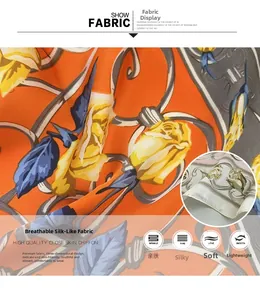 Vue macro détaillée d'un foulard en soie orange avec ourlet roulé et imprimé floral