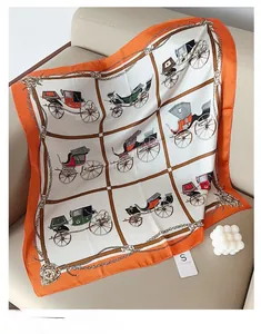Detail of square silk scarf featuring vintage carriage patterns and orange borders