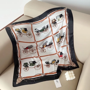 Close-up of vintage square scarf featuring classic carriage print and elegant black border