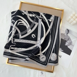 Elegant 70cm black square silk scarf with chain pattern on a gold decorative tray