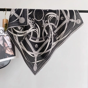 Detail of the equestrian chain pattern print on a luxury silk feel square scarf
