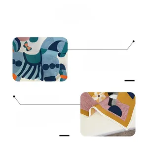Detail view of abstract geometric print on silk scarf showing fine edge stitching quality
