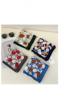 Flat lay detail of four tulip print square scarves in vibrant colors with fashion magazine
