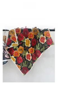 Detailed view of floral print on vintage black cotton-feel scarf with elegant edging