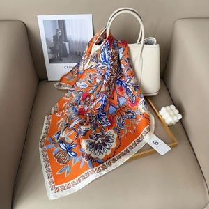 70cm vintage floral satin silk scarf in warm orange and blue draped over a handbag