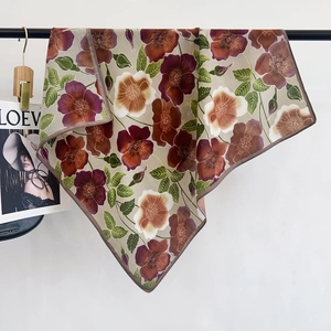 Close-up of vintage floral print cotton scarf showing detailed hem and silky texture