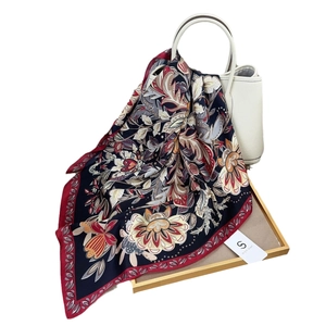 70cm navy blue floral silk-like square scarf draped elegantly over a luxury handbag