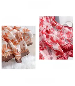 Detailed close-up of floral print silk satin scarf with elegant stitched hem and soft texture