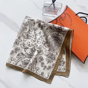 Detail of silk-feel square scarf with vintage paisley patterns and coffee brown borders