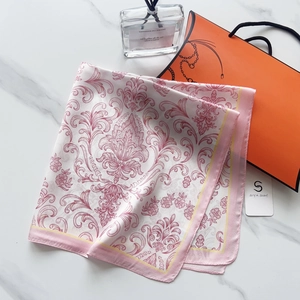 Close-up of pink baroque patterns on a 58cm silk-like square scarf with yellow border