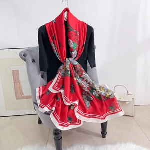 Detailansicht des roten Seidenschals mit Blumenmuster und gestreiftem Randdekor