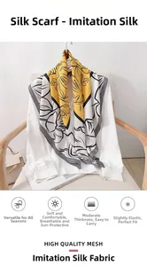 Detail of yellow and grey floral imitation silk scarf styled on a white shirt