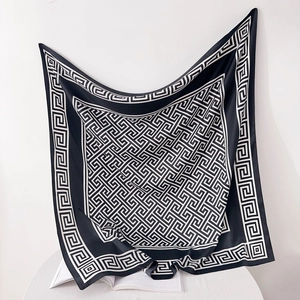 Detailed view of large 90cm square silk scarf with black and white Greek key pattern