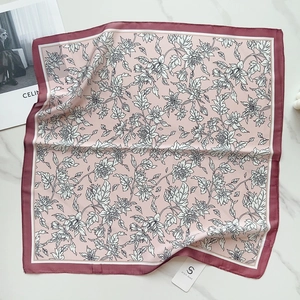 Detailed view of pink floral silk-like square scarf with elegant black outlines