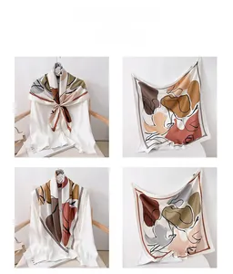 Detail view of large square silk scarf with geometric patterns in earthy tones for women