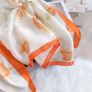 Eleganter elfenbeinfarbener Seidenschal mit orangefarbenem Blumendruck und Satinstruktur