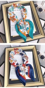 Detailed close-up of floral satin square scarves in blue and orange elegant patterns