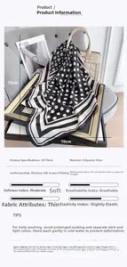 Detailed view of black and white polka dot silk scarf with dimensions 70x70cm on beige bag